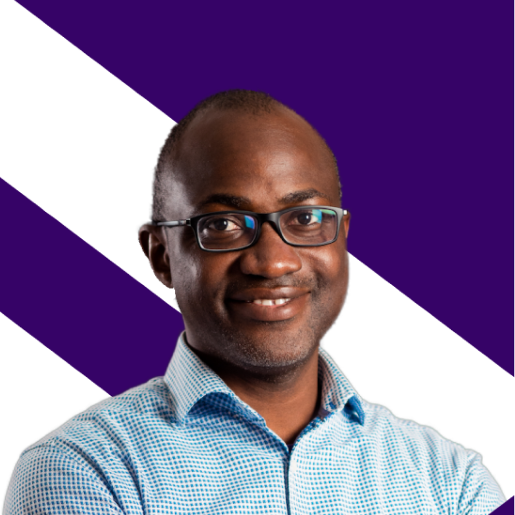 Yannick Lefang, Founder and CEO of KASI Insight, smiling and wearing reading glasses and a blue formal shirt, with crossed hands across his chest.